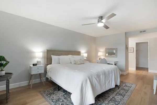 a bedroom with a bed and a lamp