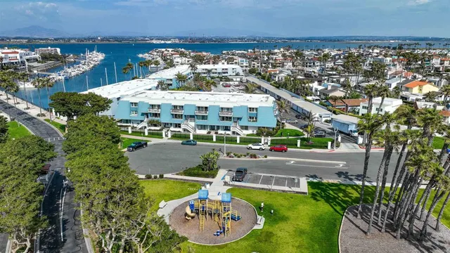 an aerial view of a house with a garden and lake view