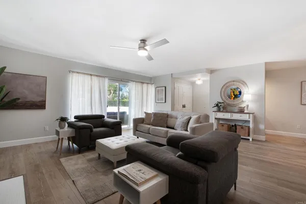 a living room with furniture and a wooden floor