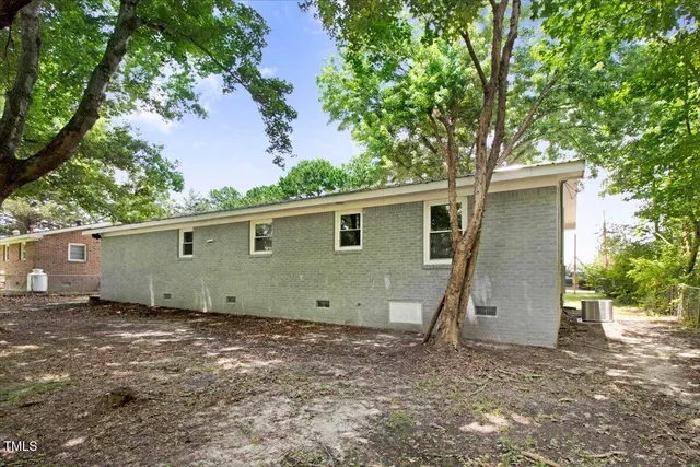 a view of a house with a large tree