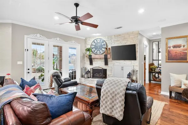 a bedroom with a large bed and a chandelier fan