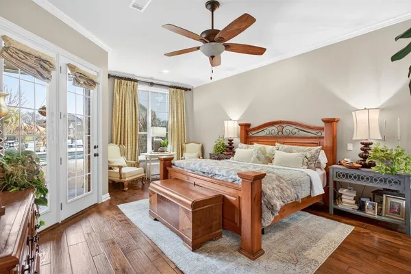 a bedroom with a bed and a large mirror on the dresser