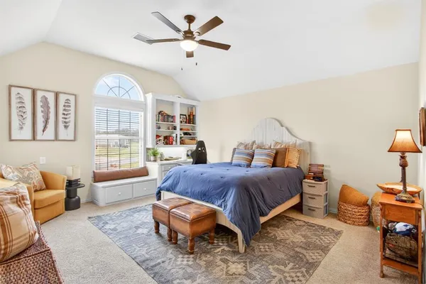 a living room with furniture a large window and a chandelier
