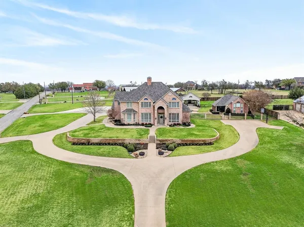 an aerial view of a house with a garden and trees