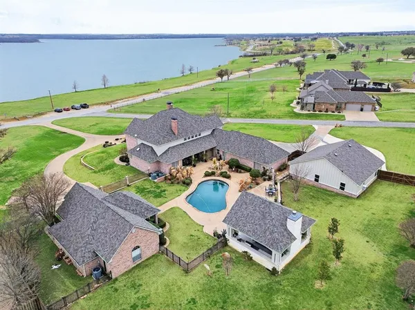 an aerial view of a house with outdoor space patio and lake view
