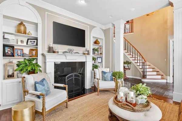 a living room with furniture fireplace and flat screen tv