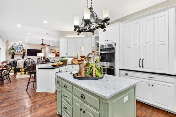a kitchen with lots of counter space and wooden floor