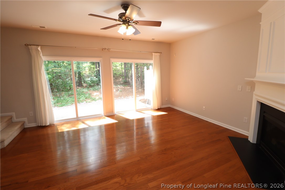 7122 Racine Way Raleigh, NC 27615 - Photo 12 of 32 a view of empty room with wooden floor and fan
