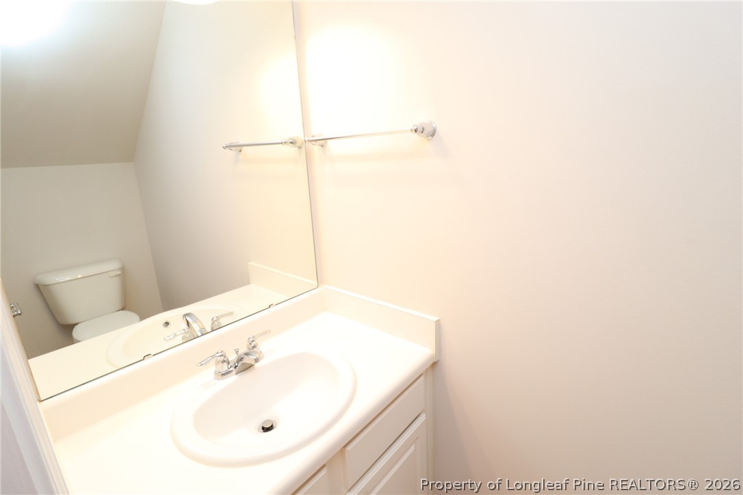7122 Racine Way Raleigh, NC 27615 - Photo 15 of 32 a bathroom with a sink and a mirror