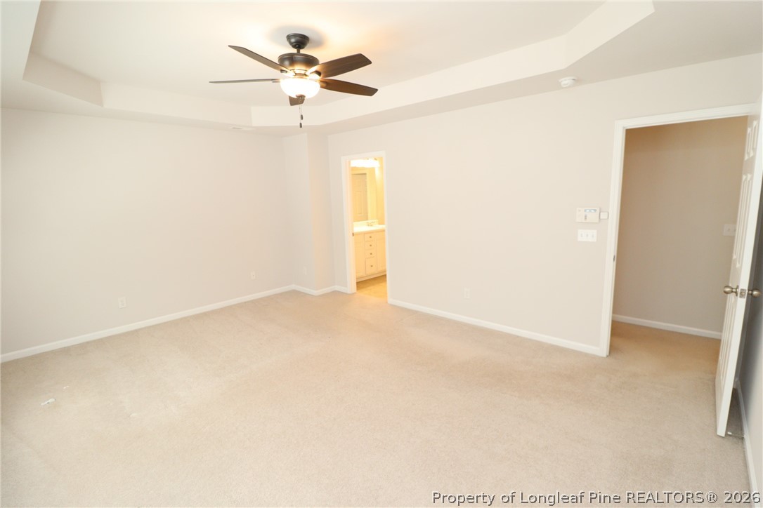 7122 Racine Way Raleigh, NC 27615 - Photo 18 of 32 an empty room with a ceiling fan and a window