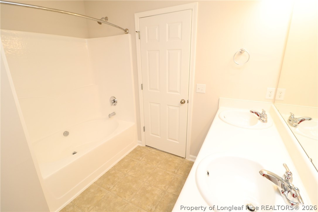 7122 Racine Way Raleigh, NC 27615 - Photo 22 of 32 a bathroom with a tub and shower