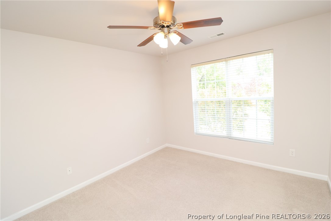 7122 Racine Way Raleigh, NC 27615 - Photo 25 of 32 an empty room with a window and a fan