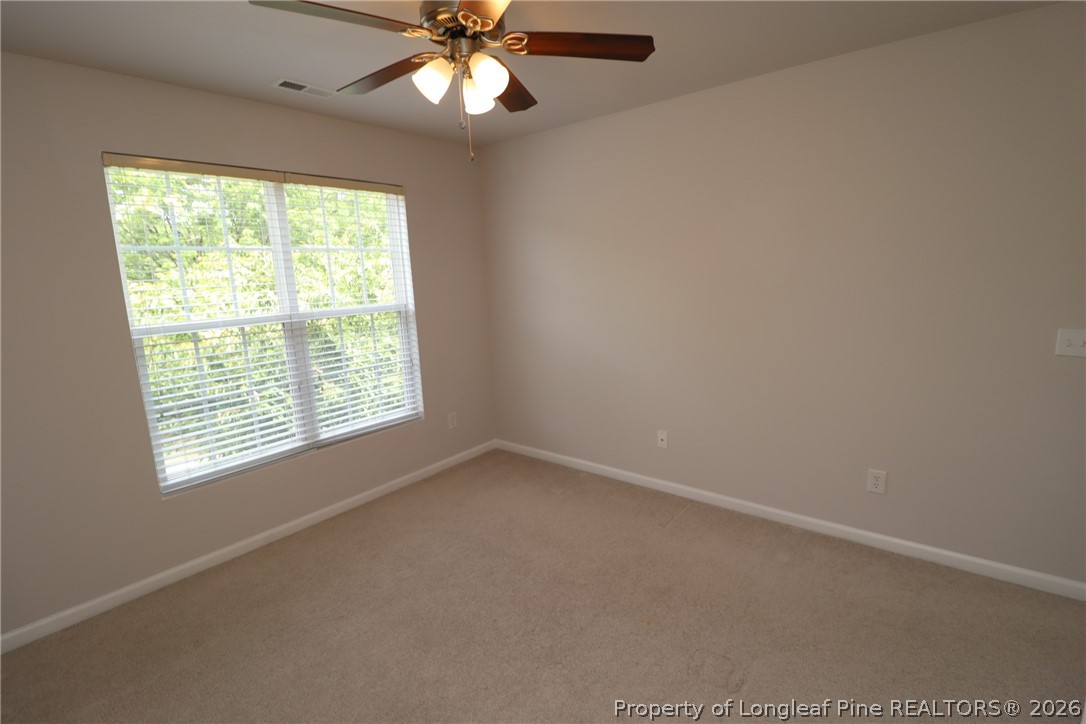 7122 Racine Way Raleigh, NC 27615 - Photo 27 of 32 an empty room with a window and a fan