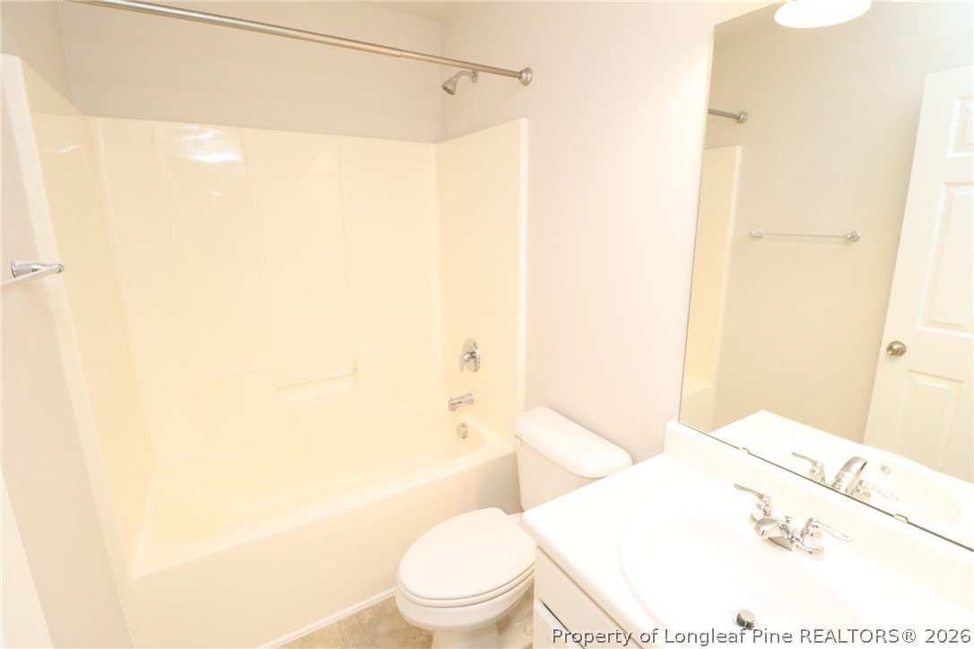 7122 Racine Way Raleigh, NC 27615 - Photo 30 of 32 a white toilet sitting next to a bathroom sink