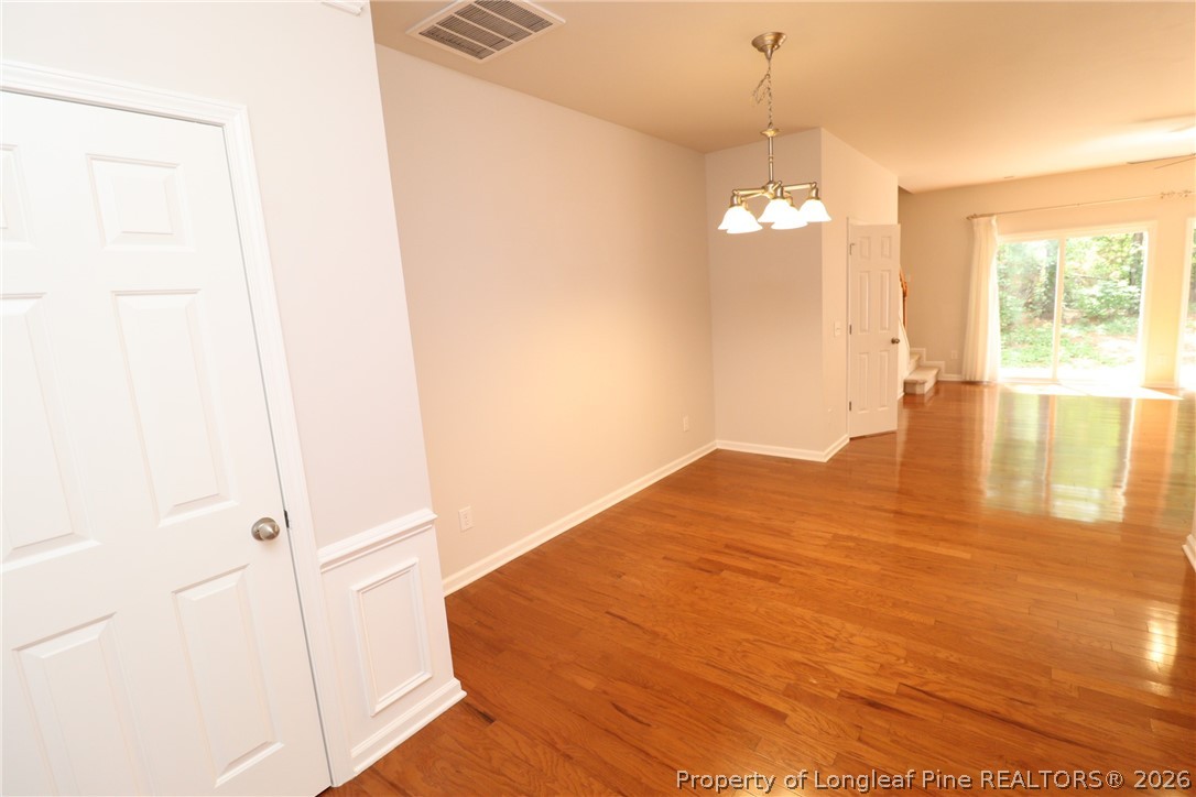 7122 Racine Way Raleigh, NC 27615 - Photo 4 of 32 a view of empty room with wooden floor and fan