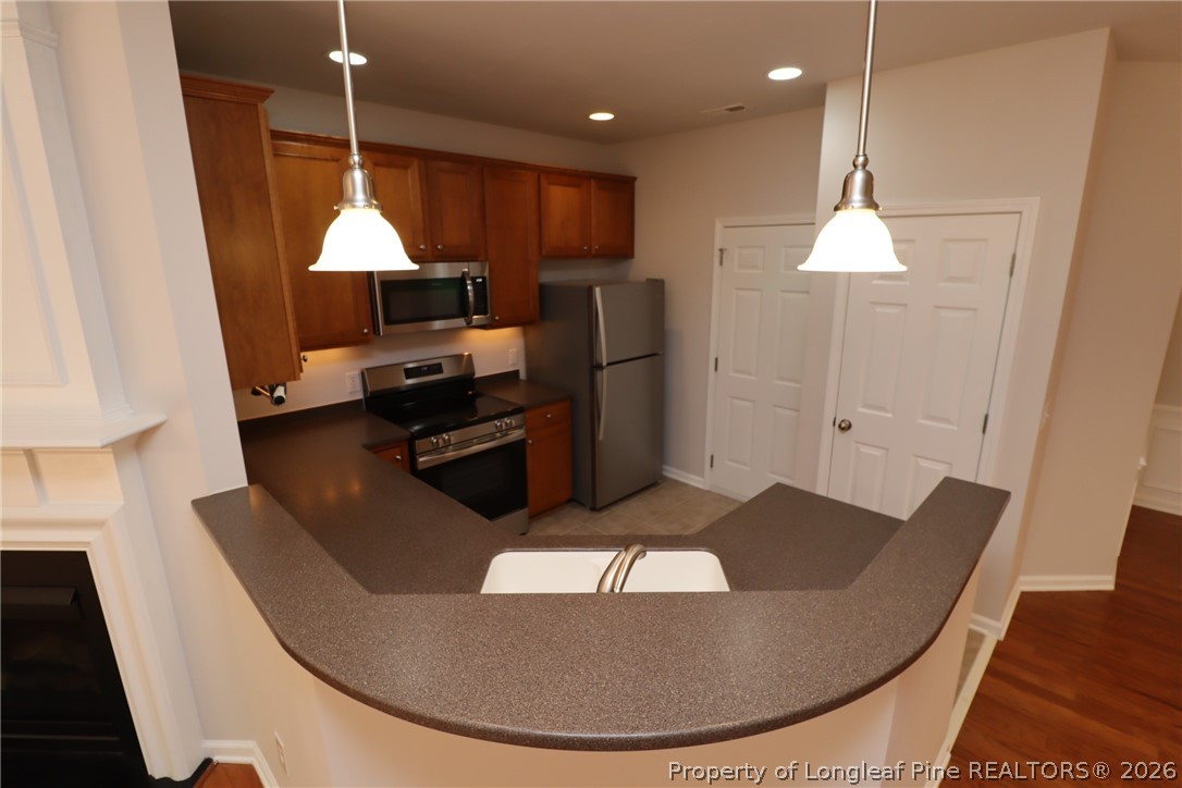 7122 Racine Way Raleigh, NC 27615 - Photo 6 of 32 a kitchen with a table and chairs