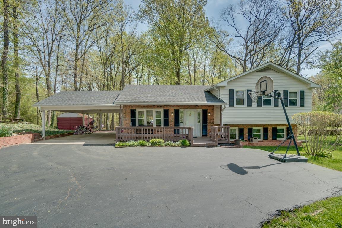 13663 Van Doren Road Manassas, VA 20112 - Photo 1 of 33 a front view of a house with a garden and sitting area