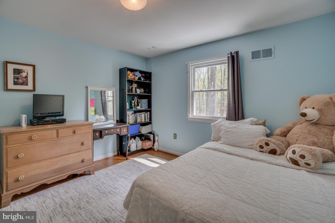 13663 Van Doren Road Manassas, VA 20112 - Photo 20 of 33 a bedroom with a bed and a flat screen tv
