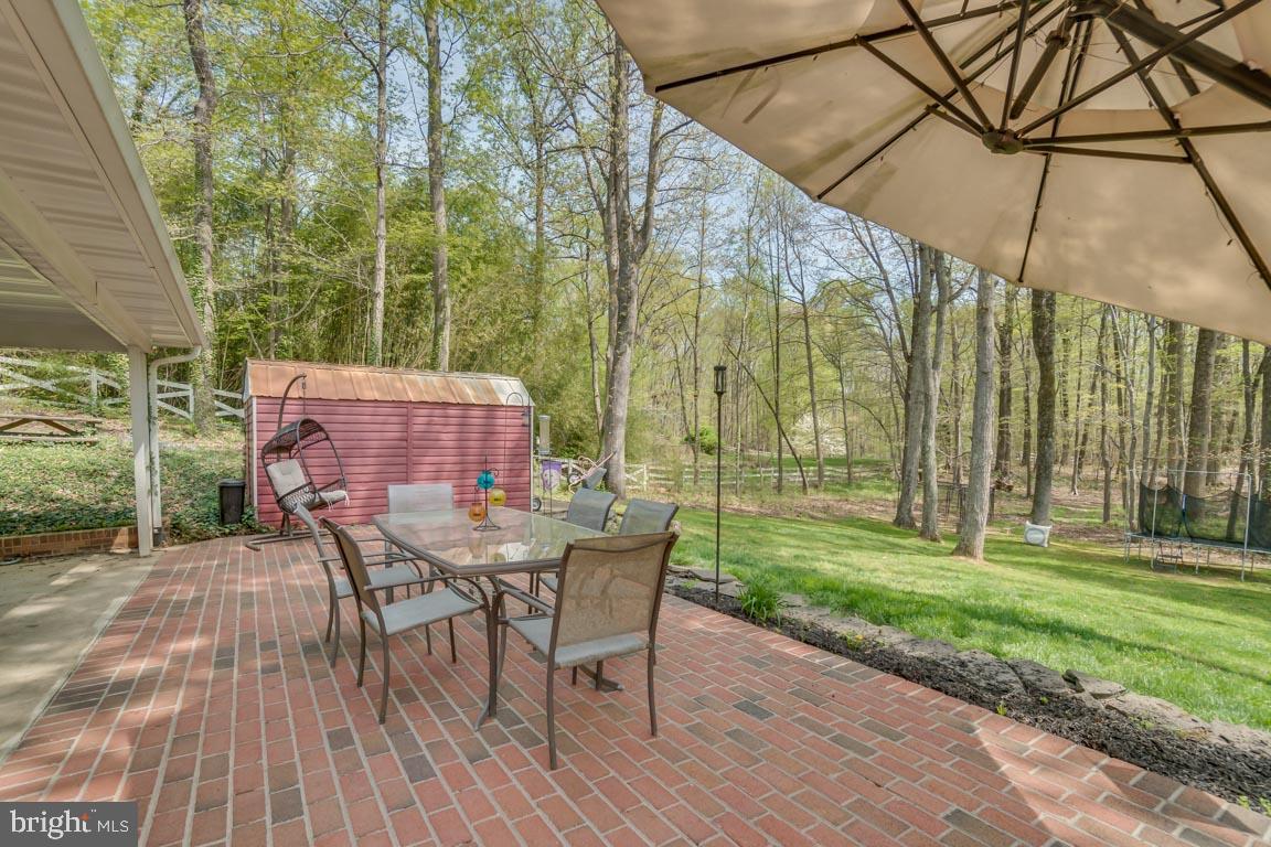 13663 Van Doren Road Manassas, VA 20112 - Photo 29 of 33 a patio with table and chairs and potted plants