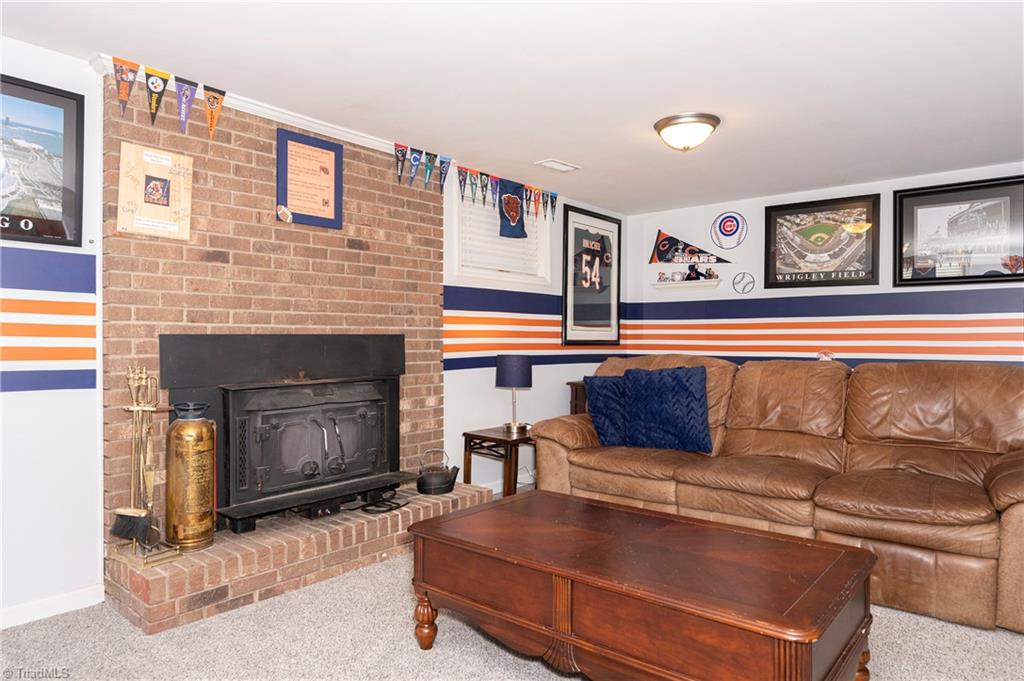 159 Wills Road Advance, NC 27006 - Photo 8 of 48 Lower Level Den with Masonry fireplace hearth and woodstove with blower