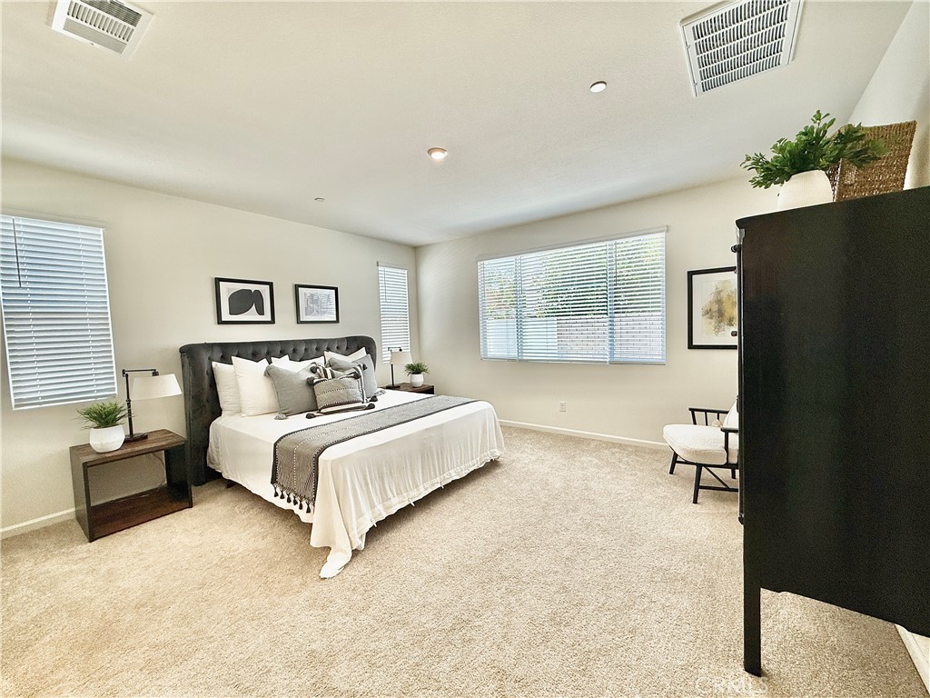 36237 Sunset Ridge Court Wildomar, CA 92595 - Photo 14 of 41 a spacious bedroom with a bed couch and a window