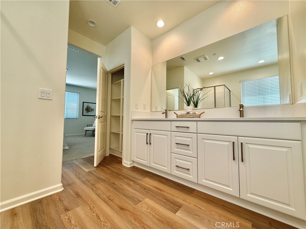 36237 Sunset Ridge Court Wildomar, CA 92595 - Photo 17 of 41 a spacious bathroom with a granite countertop sink mirror and