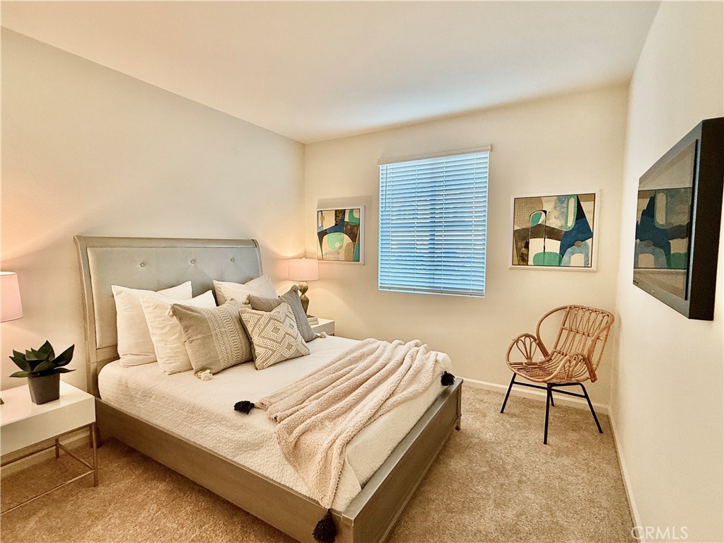 36237 Sunset Ridge Court Wildomar, CA 92595 - Photo 26 of 41 a bedroom with a bed a couch and dresser