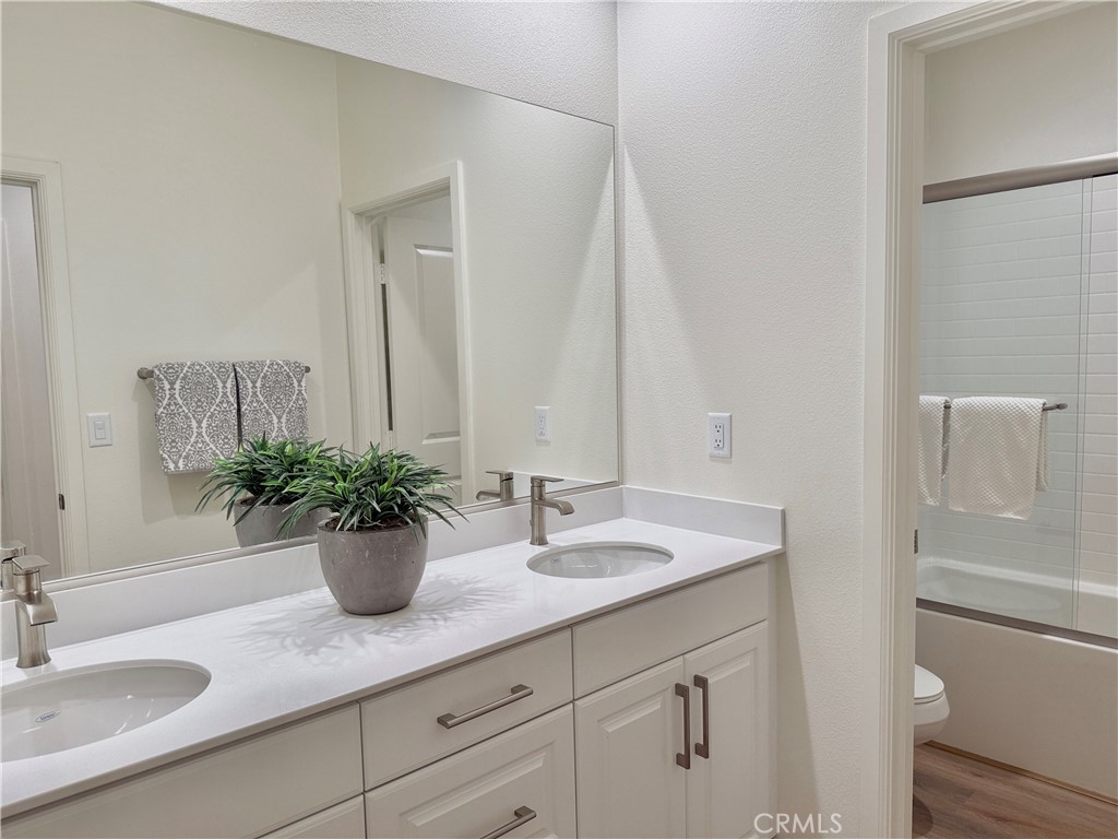 36237 Sunset Ridge Court Wildomar, CA 92595 - Photo 29 of 41 a bathroom with a sink a mirror and a toilet