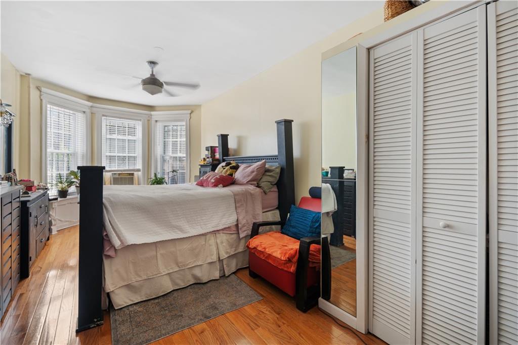 8 Raleigh Place Brooklyn, NY 11226 - Photo 11 of 21 a bed room with a bed and a chandelier