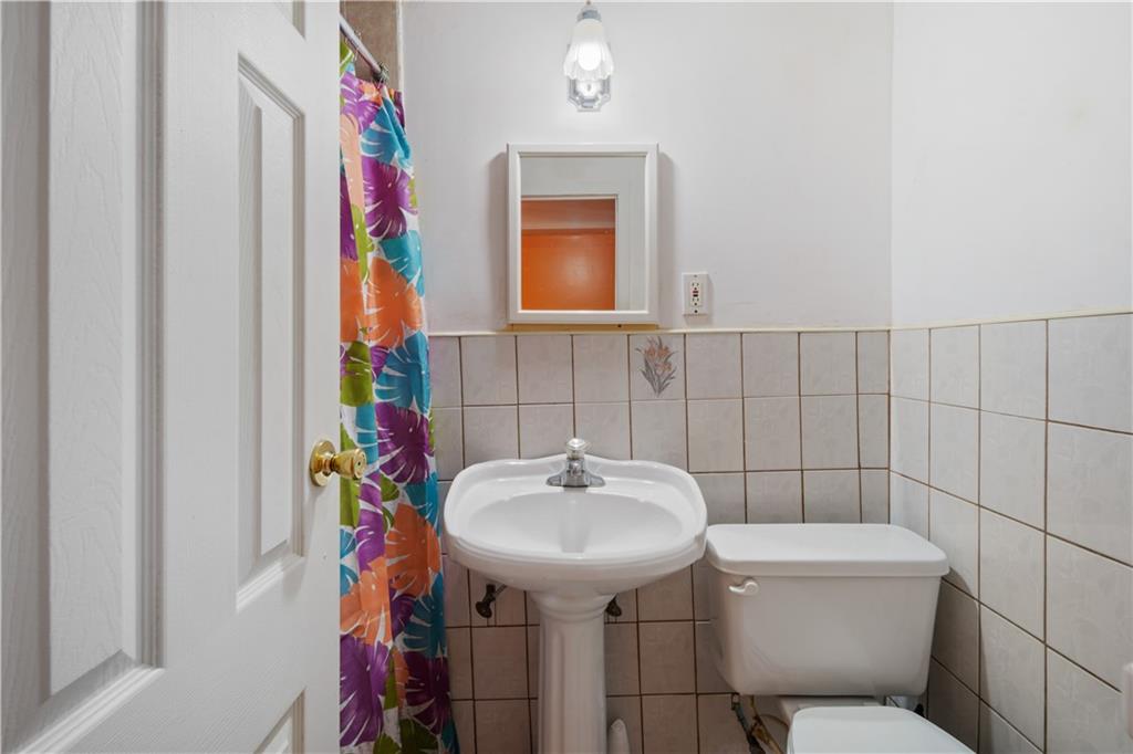 8 Raleigh Place Brooklyn, NY 11226 - Photo 16 of 21 a bathroom with a sink toilet and mirror