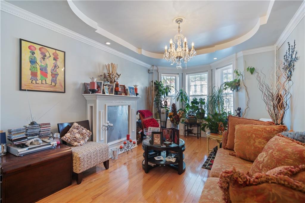 8 Raleigh Place Brooklyn, NY 11226 - Photo 4 of 21 a living room with furniture and a chandelier