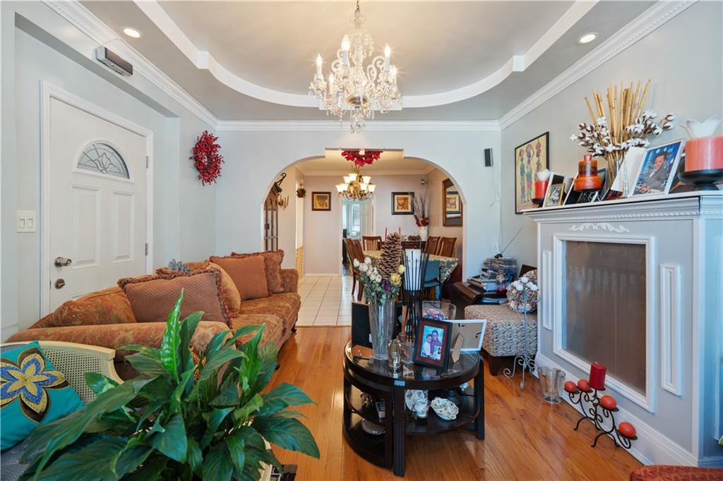 8 Raleigh Place Brooklyn, NY 11226 - Photo 6 of 21 a living room filled with furniture and a chandelier