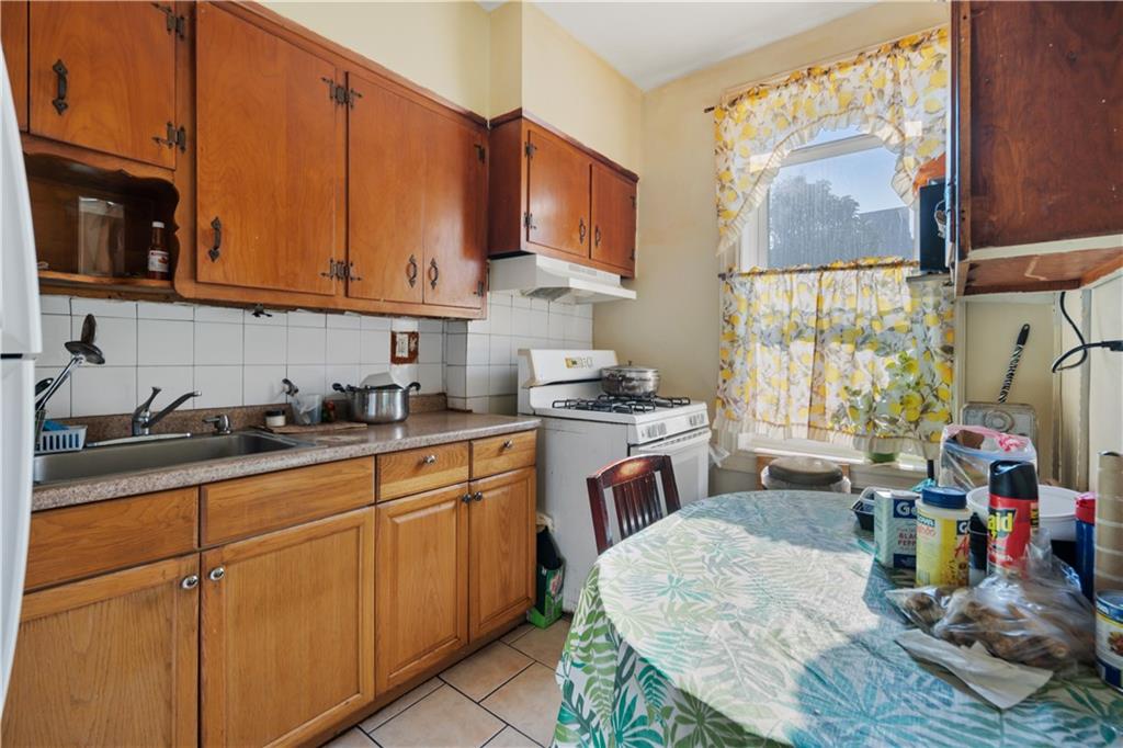 8 Raleigh Place Brooklyn, NY 11226 - Photo 8 of 21 a kitchen with stainless steel appliances granite countertop a sink dishwasher and cabinets with wooden floor