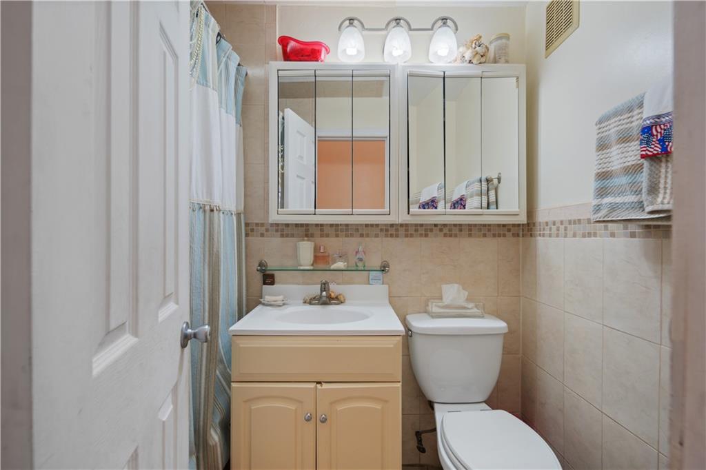 8 Raleigh Place Brooklyn, NY 11226 - Photo 9 of 21 a bathroom with a toilet and a sink