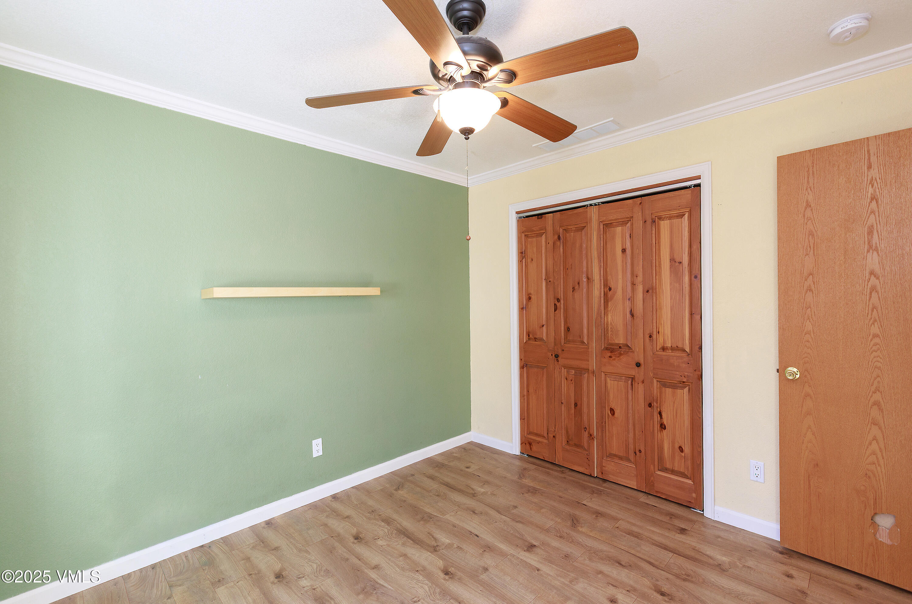 510 Brush Creek Terrace, Unit G3 Eagle, CO 81631 - Photo 21 of 29 an empty room with wooden floor fan and windows