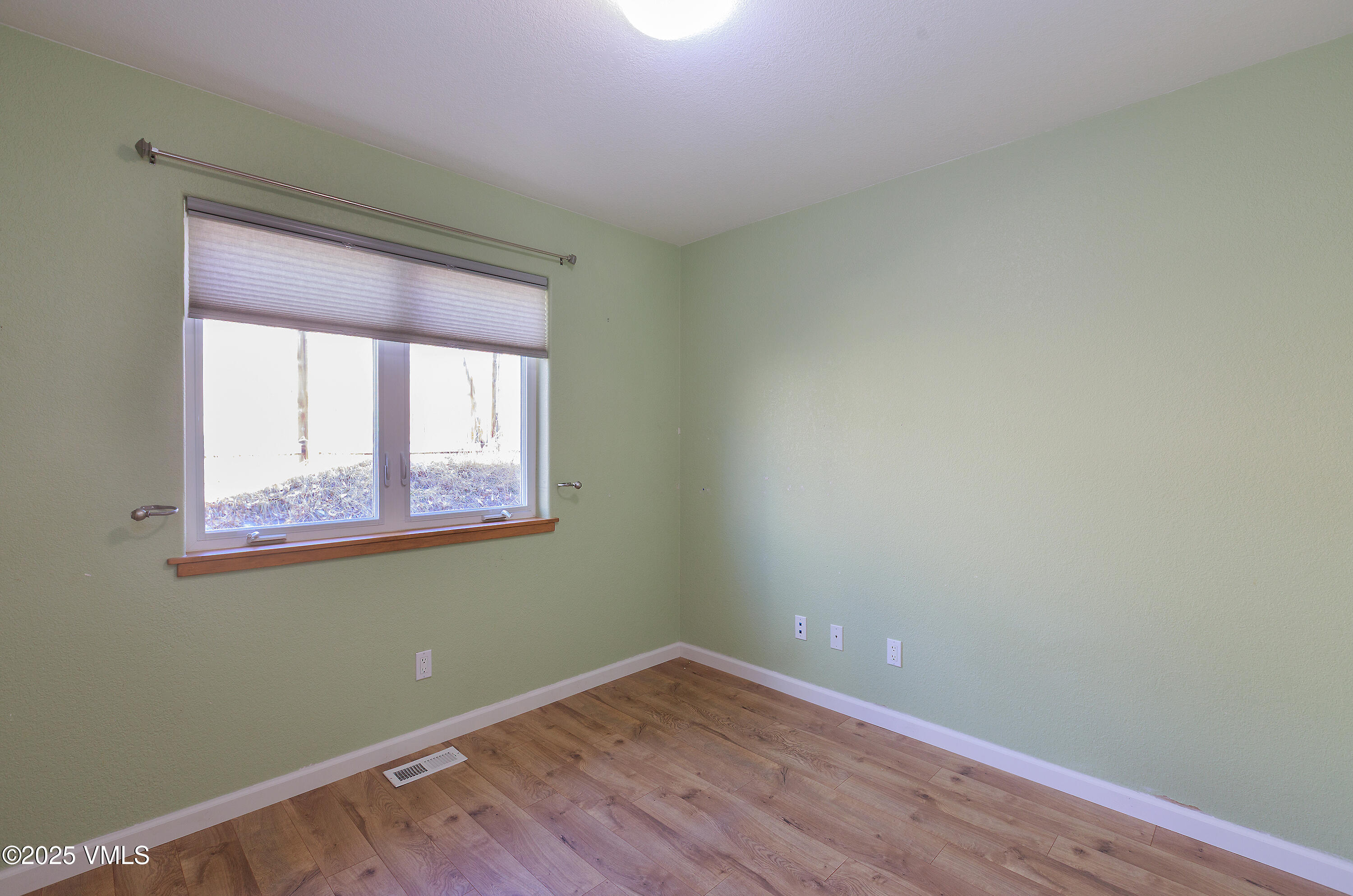 510 Brush Creek Terrace, Unit G3 Eagle, CO 81631 - Photo 23 of 29 an empty room with wooden floor and windows