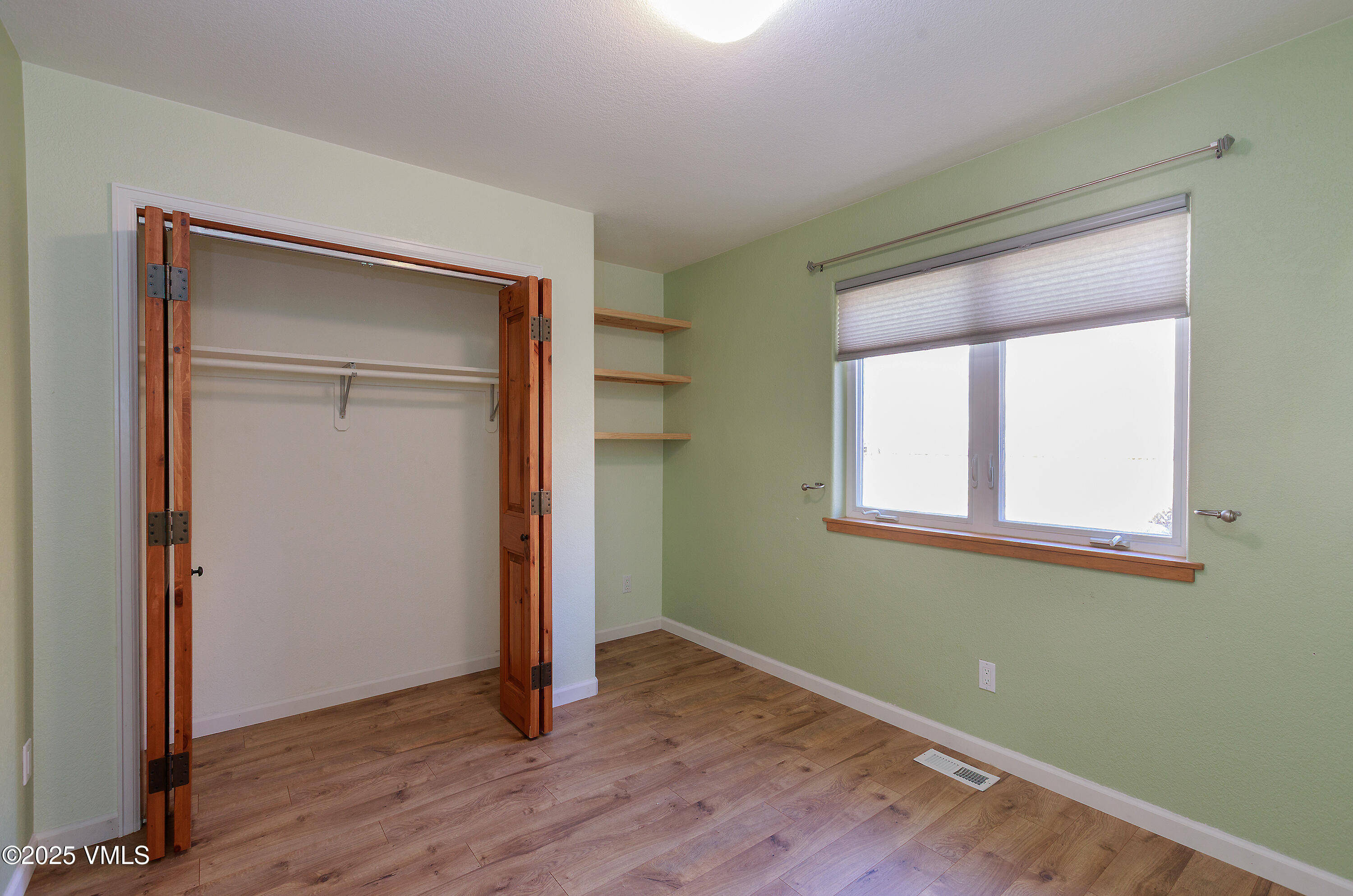 510 Brush Creek Terrace, Unit G3 Eagle, CO 81631 - Photo 24 of 29 an empty room with wooden floor closet and windows