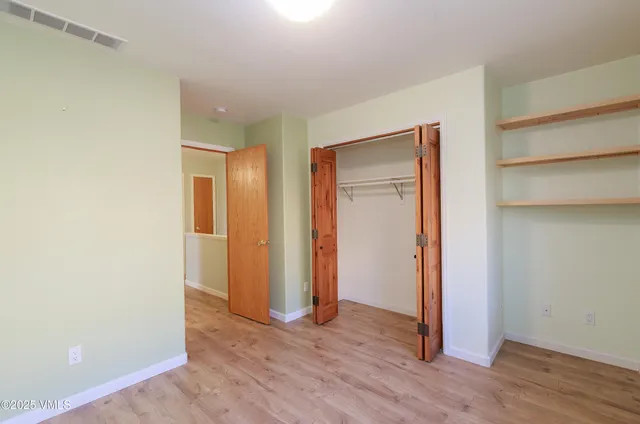 a view of a room with wooden floor