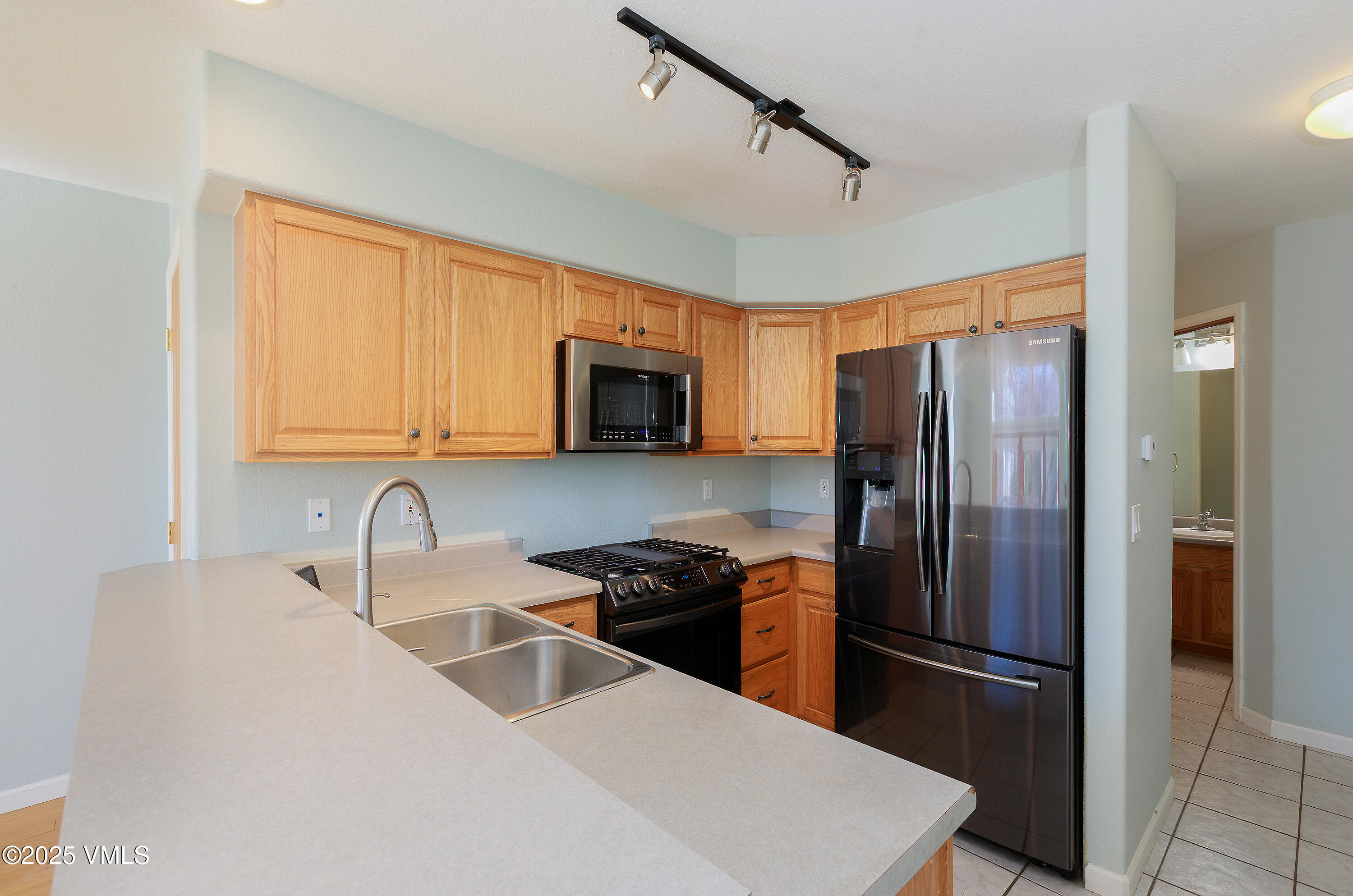 510 Brush Creek Terrace, Unit G3 Eagle, CO 81631 - Photo 10 of 29 a kitchen with stainless steel appliances a refrigerator sink and microwave