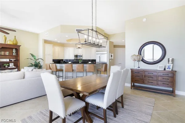 a dining room with furniture a rug and a chandelier