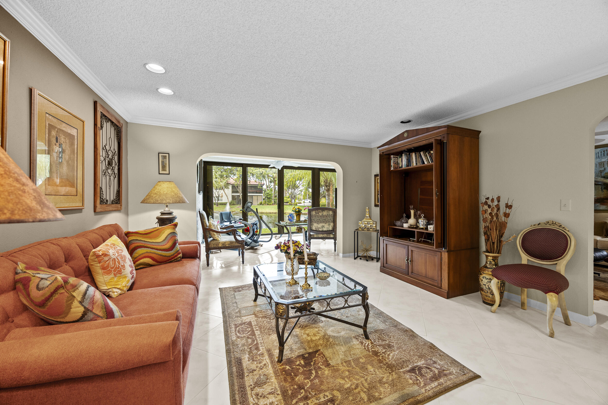21691 Tall Palm Circle, Unit 3C Boca Raton, FL 33433 - Photo 12 of 48 a living room with furniture and a flat screen tv