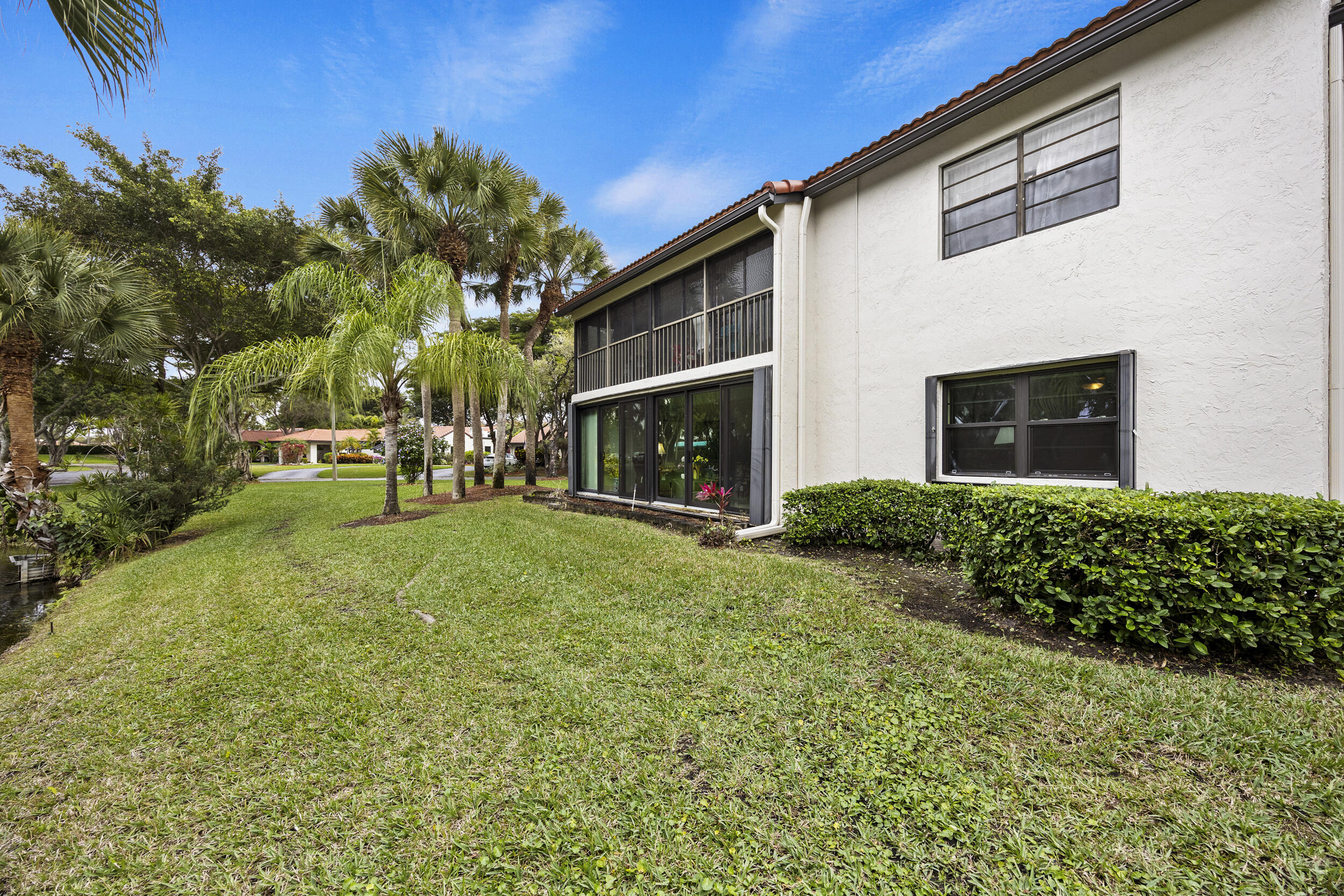 21691 Tall Palm Circle, Unit 3C Boca Raton, FL 33433 - Photo 23 of 48 a view of an house with backyard space and garden