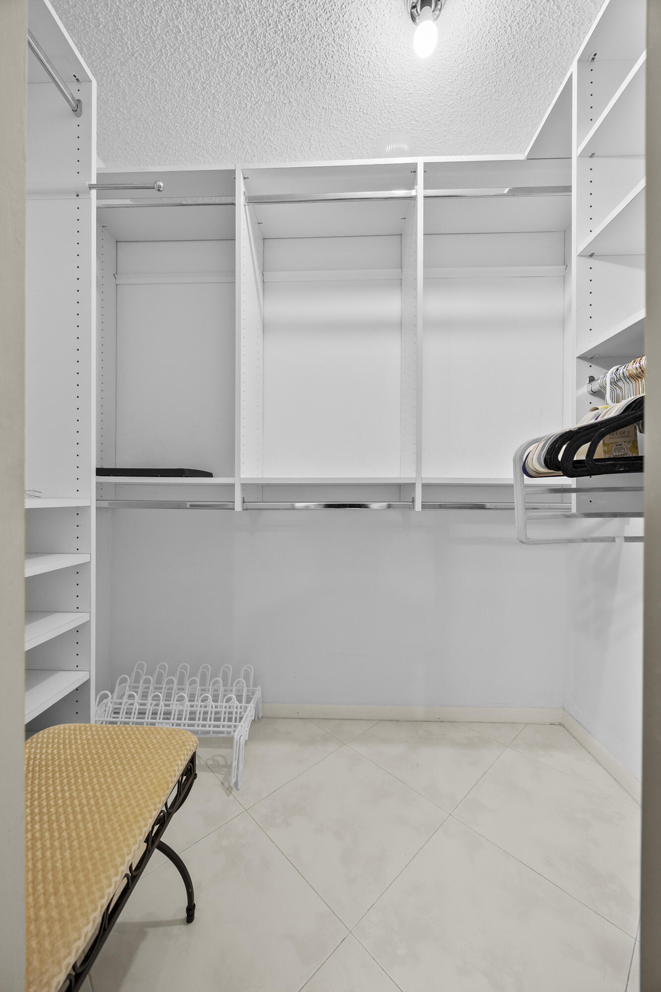 21691 Tall Palm Circle, Unit 3C Boca Raton, FL 33433 - Photo 28 of 48 a view of an empty walk in closet