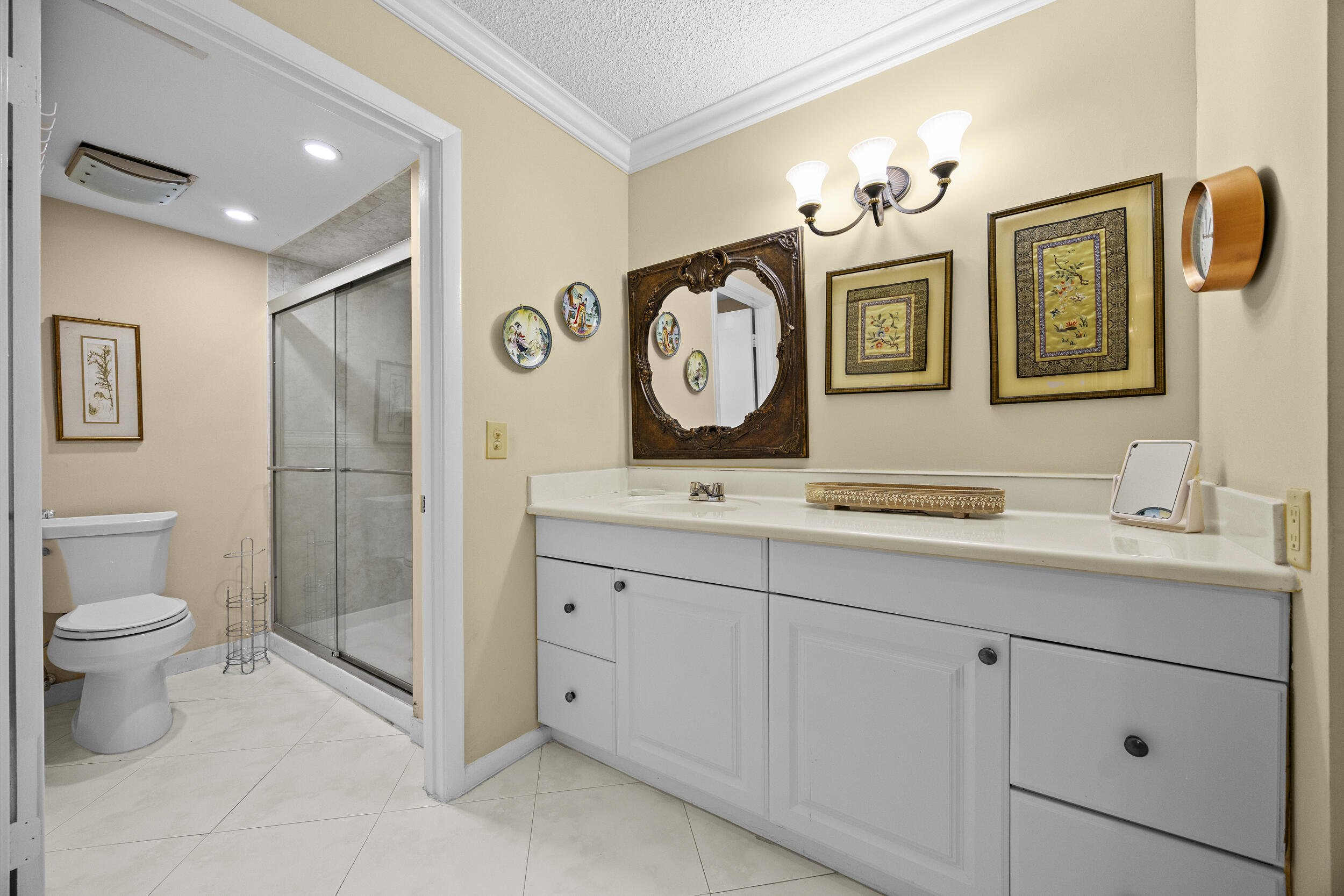 21691 Tall Palm Circle, Unit 3C Boca Raton, FL 33433 - Photo 29 of 48 a bathroom with a toilet a sink and a mirror