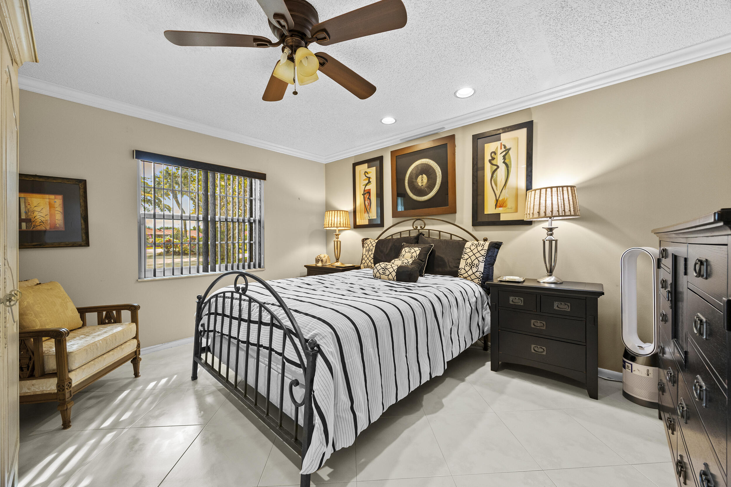 21691 Tall Palm Circle, Unit 3C Boca Raton, FL 33433 - Photo 30 of 48 a bedroom with a bed and a chandelier