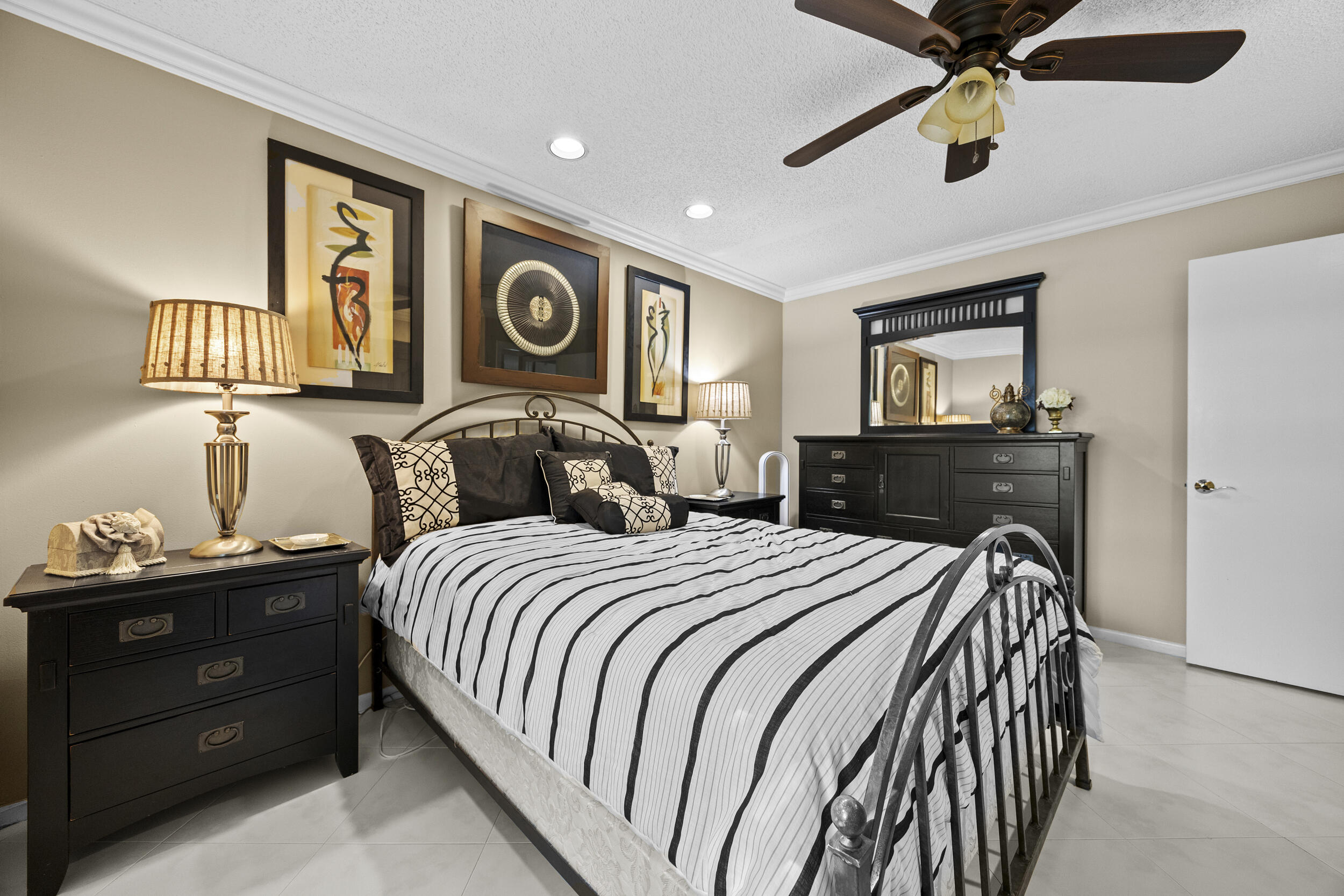 21691 Tall Palm Circle, Unit 3C Boca Raton, FL 33433 - Photo 33 of 48 a bedroom with a bed and dresser