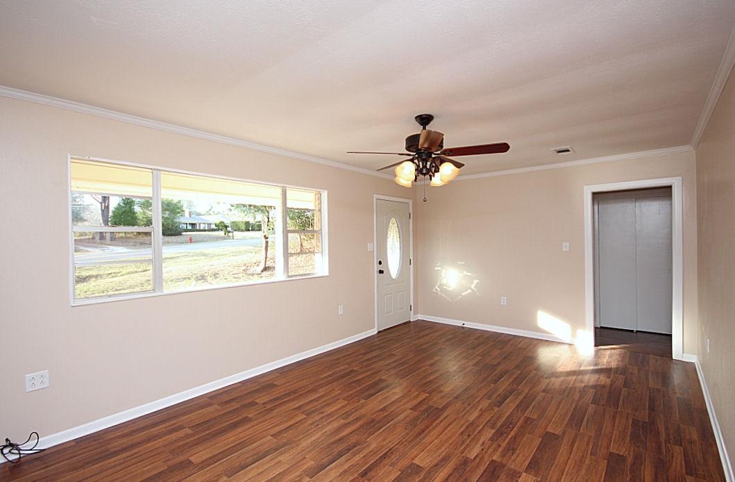 5643 Old Bethel Road Crestview, FL 32536 - Photo 7 of 23 a view of an empty room with wooden floor and a window