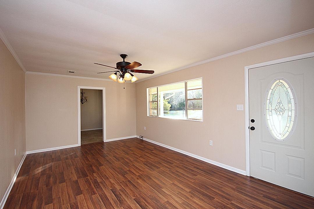 5643 Old Bethel Road Crestview, FL 32536 - Photo 8 of 23 a view of a livingroom with wooden floor and a ceiling fan