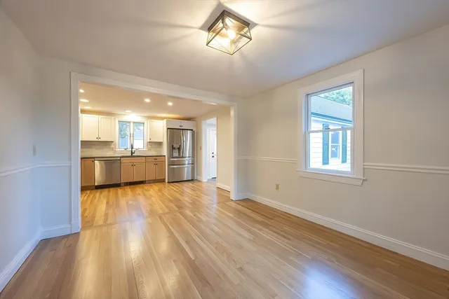 a view of a kitchen with wooden floor and a kitchen