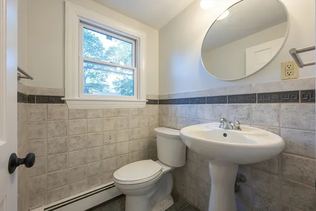 a bathroom with a sink a toilet and mirror